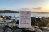 Do Hope book on stone wall with town harbour scene in background 