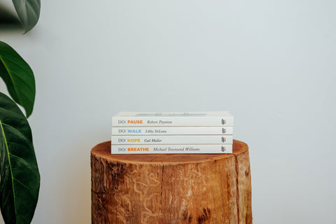 Pile of books on wooden log